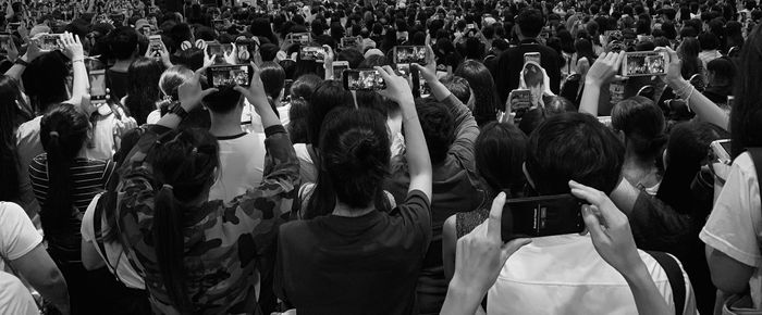 Rear view of people photographing