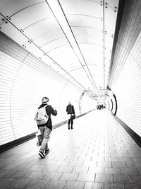 Rear view of people walking on footpath