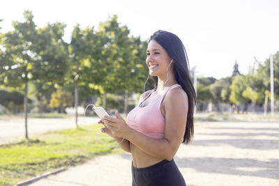 Athlete woman with mobile phone in hand before running