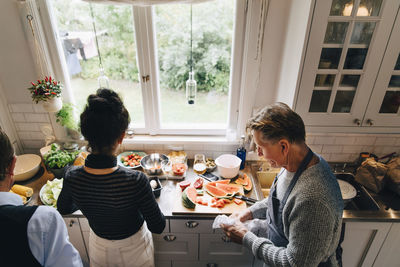 Rear view of couple sitting on table at home