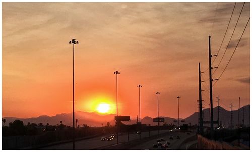 Traffic on road at sunset