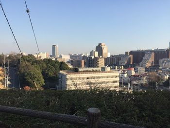 Buildings in city against clear sky