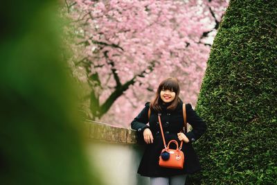 Portrait of smiling beautiful woman in park