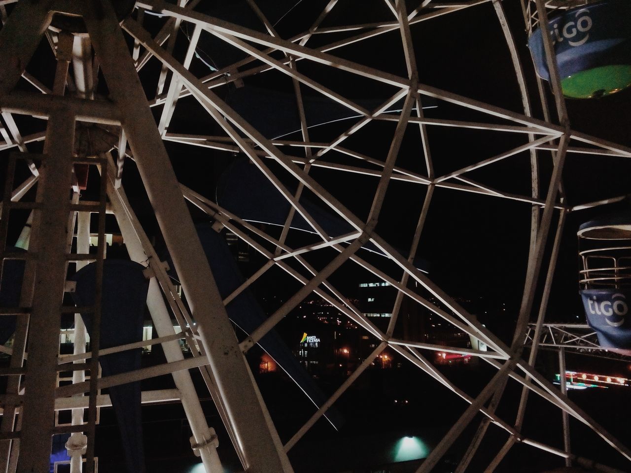 low angle view, architecture, built structure, full frame, illuminated, pattern, backgrounds, night, indoors, metal, building exterior, ceiling, geometric shape, design, architectural feature, decoration, circle, lighting equipment, no people, arts culture and entertainment