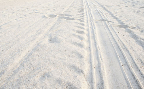 High angle view of tire tracks on beach