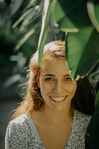 A close up portrait of a young smiling woman