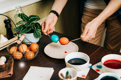 Easter day. father and son paint eggs. preparing for easter decoration. child kid boy having fun