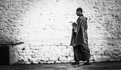 Boy standing against wall