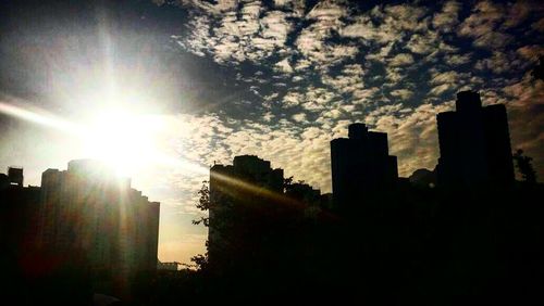 Silhouette city against sky