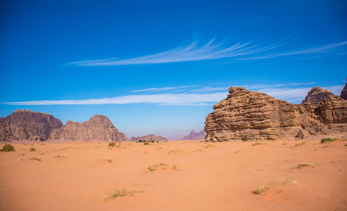 Scenic view of desert against blue sky