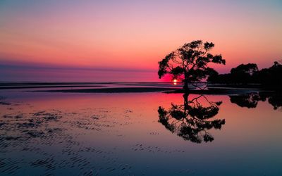 Scenic view of sea against orange sky