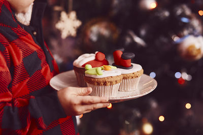 Midsection of woman holding cake