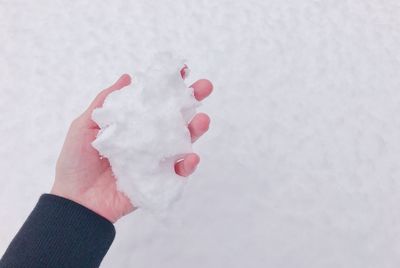 Close-up of hand holding ice cream cone during winter