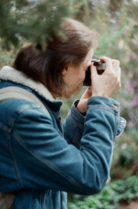 Young woman photographing with camera