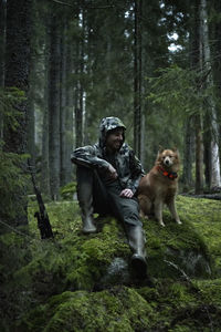 Hunter with dog in forest