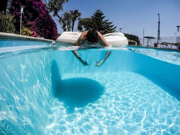 Man on pool raft in swimming pool