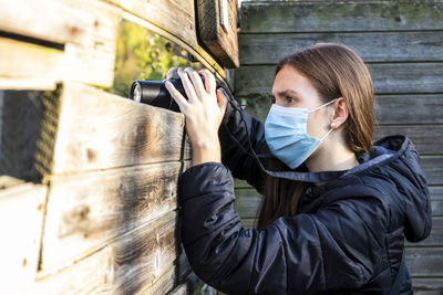 Portrait of woman photographing