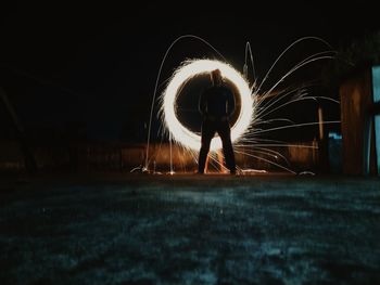 Illuminated light trails on field at night