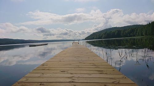 Pier over lake against sky