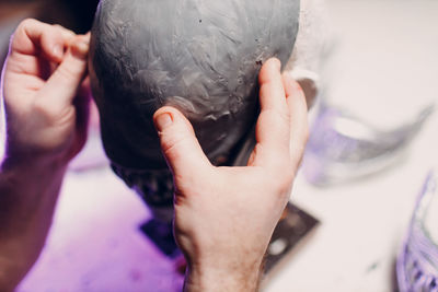 Cropped hand of artisan sculpting