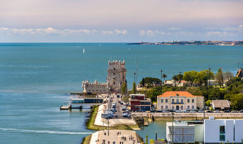 Scenic view of sea and buildings against sky