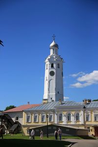 View of church and buildings against blue sky