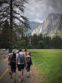 Rear view of people walking on road 