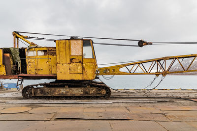 Crane at construction site against sky