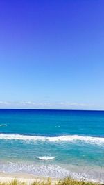 Scenic view of sea against clear blue sky