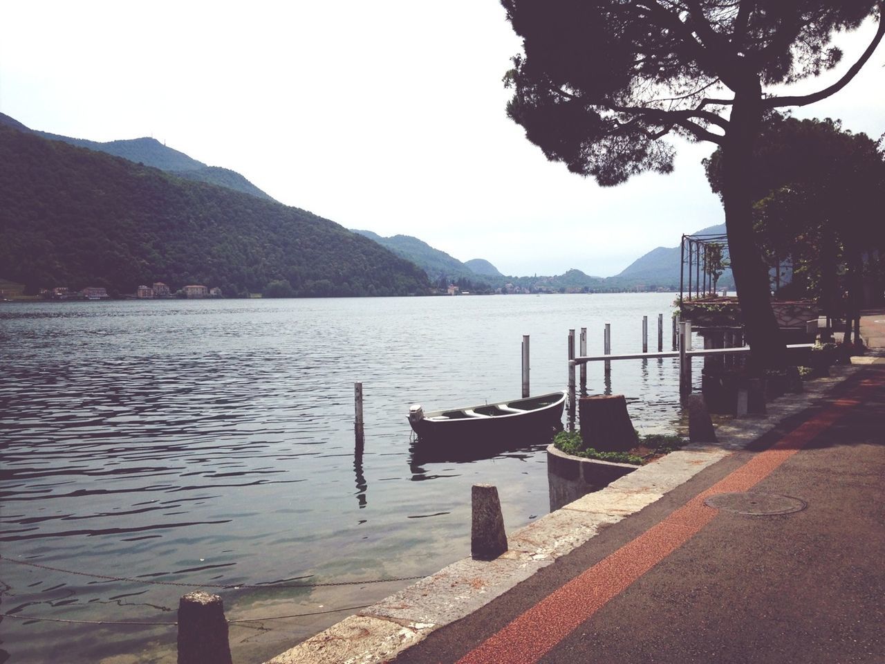 water, mountain, tranquil scene, tranquility, lake, scenics, clear sky, mountain range, beauty in nature, nature, tree, sky, river, railing, empty, idyllic, sea, pier, transportation, no people