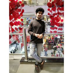 Portrait of young man standing in store