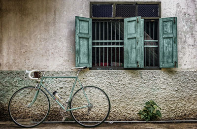 Bicycle parked in front of brick wall