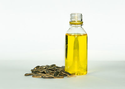 Close-up of yellow bottle against white background