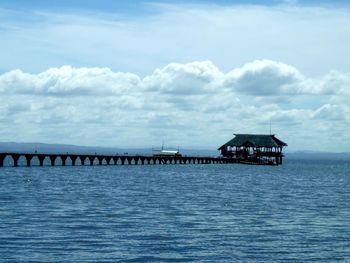 Pier over sea against sky
