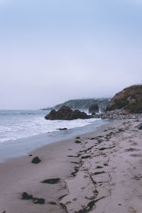 Scenic view of beach against clear sky