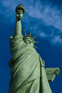 Low angle view of statue against blue sky