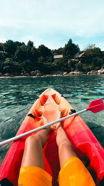 Midsection of person kayaking in sea
