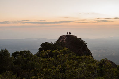 Scenic view of rock on mountain against sky during sunset