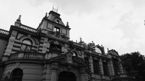 Low angle view of building against cloudy sky