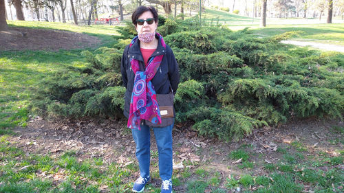 Portrait of young man wearing sunglasses standing outdoors