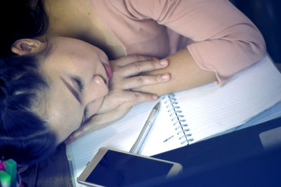 Close-up of girl lying on bed