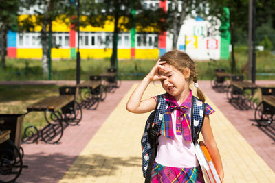 Happy girl smiling while standing outdoors