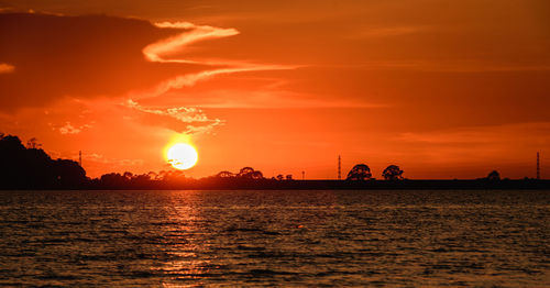 Scenic view of sea against romantic sky at sunset