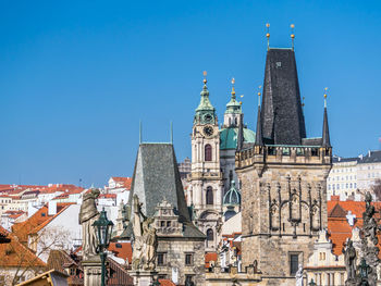 Buildings in city against blue sky