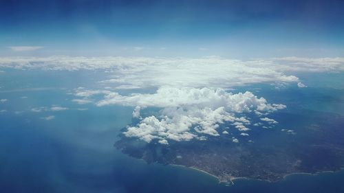 Aerial view of sea against cloudy sky