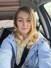 Portrait of young woman in car