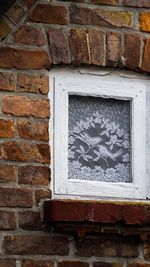 Close-up of window on brick wall