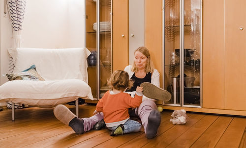 Grandmother playing with granddaughter at home