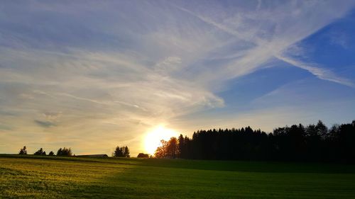 Scenic view of field against sky during sunset