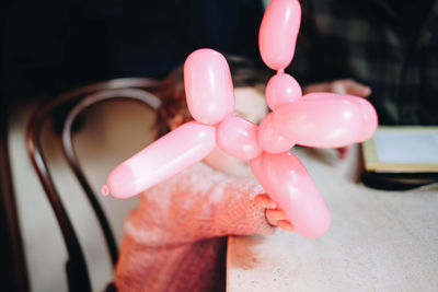 Close-up of pink holding toy